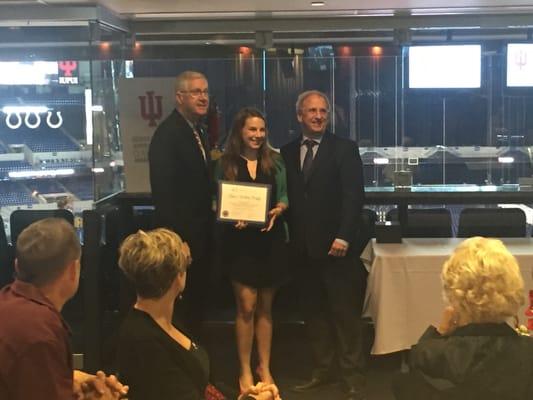 Dr. Jillian Brady accepting a award from the Prosthodontics Dept. at IU School of Dentistry.