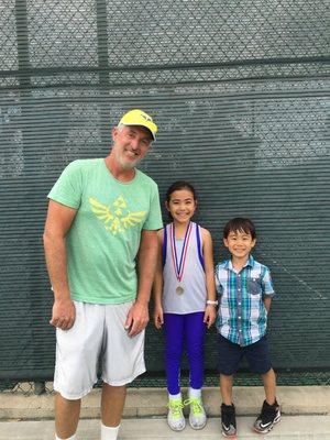 Crush Tennis coach Adam and two of his star players.