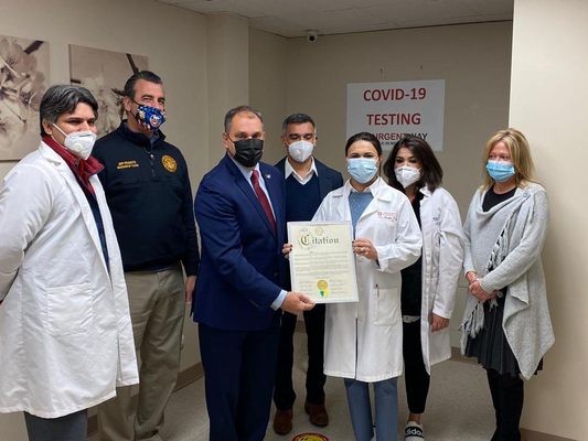 Dr Faika Khan received a recognition certificate from Supervisor Joseph Saladino at the Grand Opening of Urgentway Hicksville