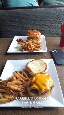 Bacon cheese burger (bottom) regular cheeseburger (top)