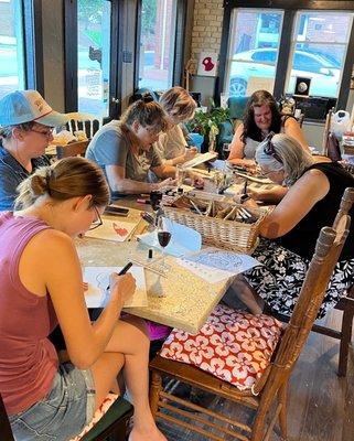 A group of women working on an art project together during a book club.