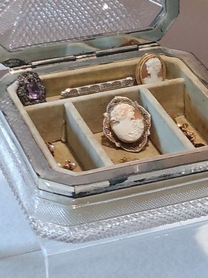 Cameos in a glass jewelry box.