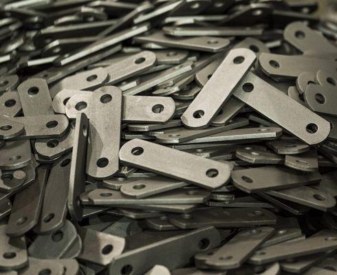 holes cut in steel hooks by a tube laser cutter