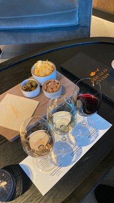 Wine flight with rosé, white, and red wines.