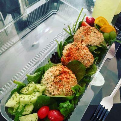 Chicken Salad On a Bed of Spring Mix, tomato, cucumber, Fruit. Lemonade