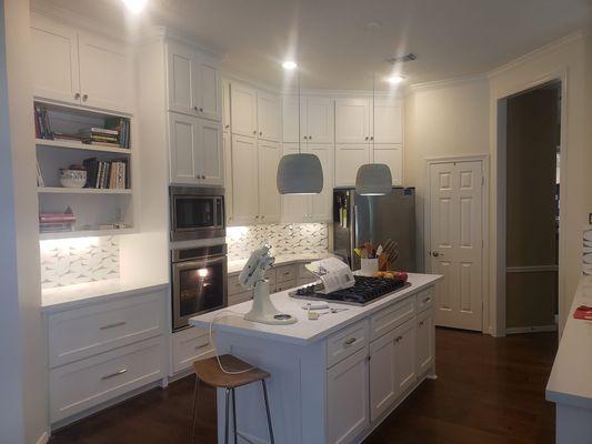 Cabinets were refaced, primed and sprayed with two coats of an oil based finish