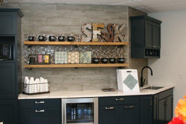 Superior Floorcoverings & Kitchens showroom. Interior view of cabinet display feauting countertop and accent wall.