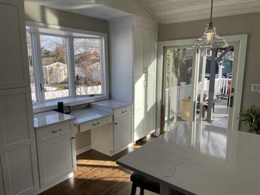 Drop-down kitchen desk with tall pantries including rollouts