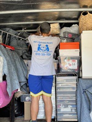 One of our strong motivated helpers organizing the truck so we can fit everything safely in one trip