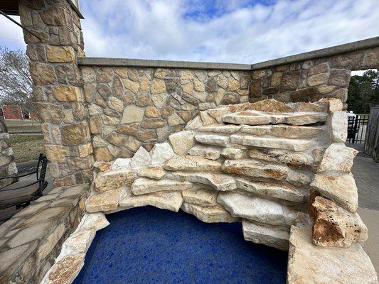 Stone waterfall with blue  tile bottom