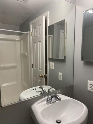 New sink installed- shower in mirror reflection