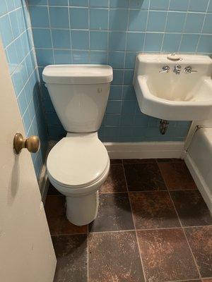 Bathroom sink, wall, floor and toilet