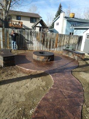 stamped concrete patio with fire pit and seat walls