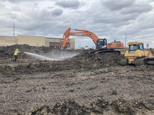 Watering dirt to begin mositure conditioing for a new Residence Inn in Grand Prairie, Tx.