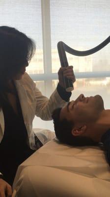 A happy client getting a CryoAir Facial