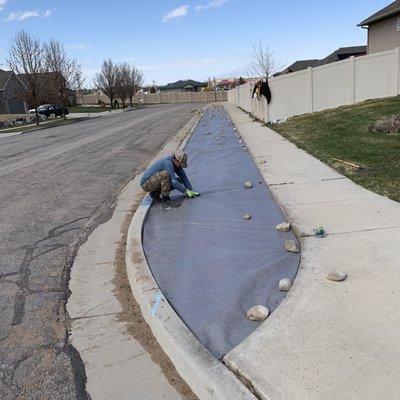 We put the weed barrier before putting rocks