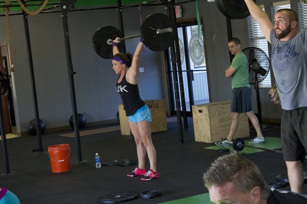 Nailing some thrusters during a CrossFit class.