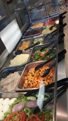 Salad bar filled with fresh fruit and veggies