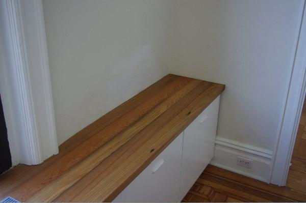 Reclaimed wood counter scribed to curvy plaster wall.