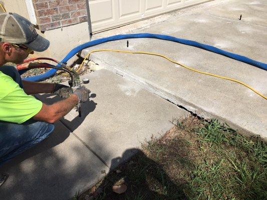 Working the sidewalk after lifting the driveway back to original