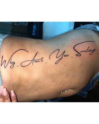 Script tattoo on side