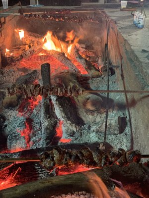 Steak tips over open pit