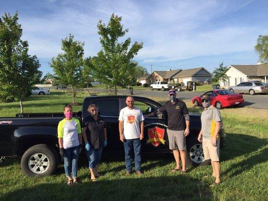 Executive Director Tim White and volunteers from Ni River Middle School serve up meals at a community cookout in Spotsylvania.