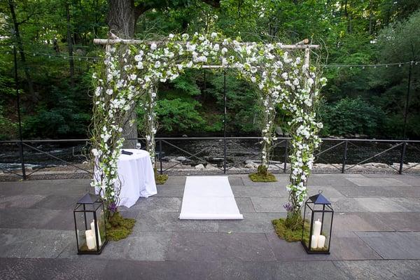 The flowered archway and aisle lanterns for our wedding ceremony.