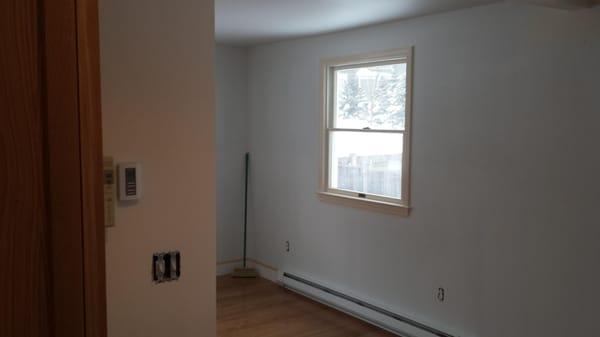 Living room after it has been primed and the trim has been painted