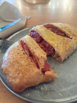 Yum!!  This is the meat pizza in a Stromboli. Can you smell the garlic!?!?  It's powerfully great!!