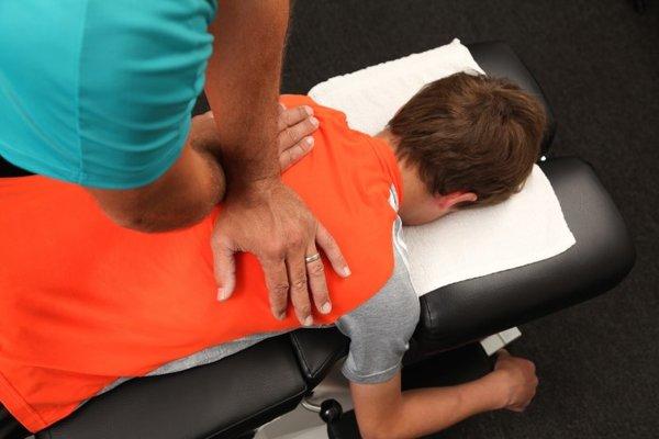 We see patients of all ages.  The Thompson (drop table) Method is used to help this young man.