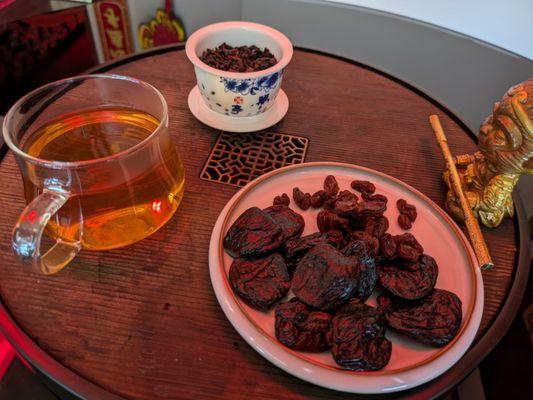 A Chinese tea tasting of ginseng tea and a snack of dates and raisins