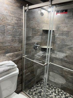 Walk-in shower with recessed lighting.