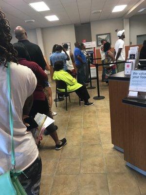 This is the line at 430pm this bank does not have a working drive thru banking. Notice the elder lady has been sitting down on line smh