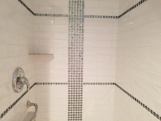 Brand new shower with shimmering glass-tile accents