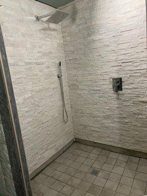 Stone wall installation for shower, tile floor, and shower mixer installation