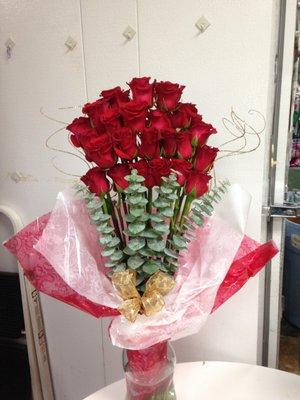 Tall and elegant romantic anniversary, with red roses and eucalyptus