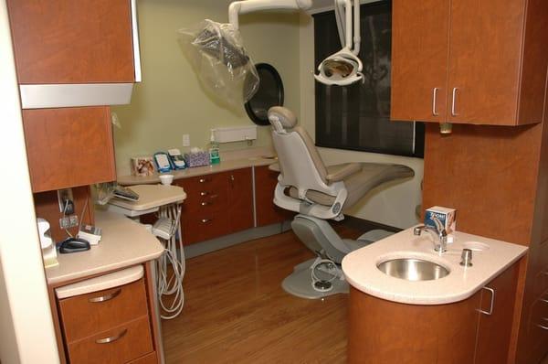 A typical operatory, featuring LED lighting, patient entertainment from overhead monitor, and ultra-comfy massage chair