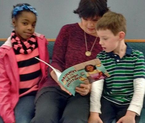 "Mimi" reads her book, "Maven & the Magic Buttons" to kids