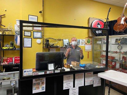 The owner, Nick, showing off the front counter in the store.