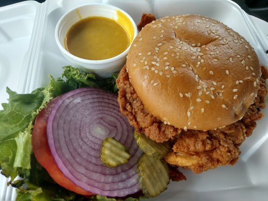 Fried chicken sandwich with honey mustard.