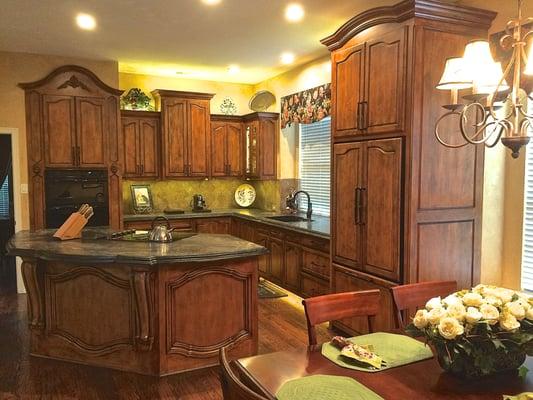 Stained and glazed maple kitchen with French curved bonnets and doors