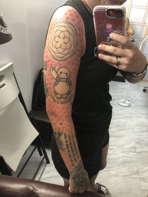 Kazan did the background to my left sleeve with the flower of life in red and orange.