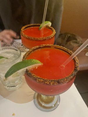 Frozen strawberry margarita with tajin on the rim.