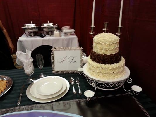 Part of our set up at the 2016 Bridal Expo.. a simple but elegant table setting featuring a simple rose cake that works for any event