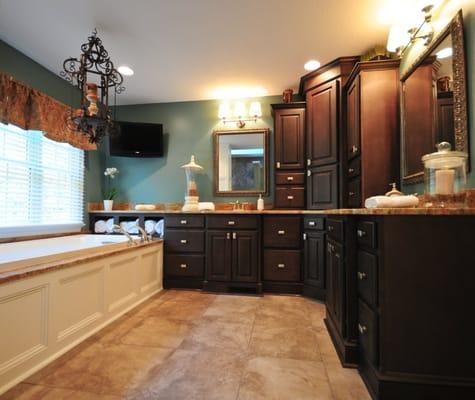 NARI CotY Award winning master bathroom featuring Maple cabinets with java stain/black glaze, granite countertops, tile floor