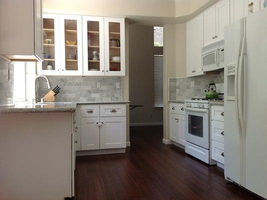 Custom white cabinets with Carrara White back-splash.