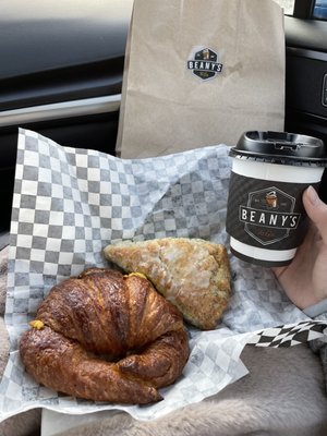 Sausage egg and cheese croissant and lemon poppy seed scone with flat white