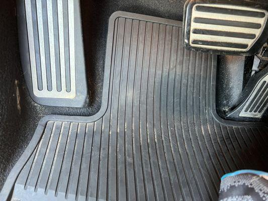 Dirty driver's side floor mat; essentially untouched