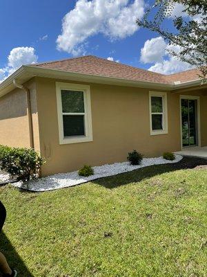 White marble stone wrapping entire property after clearing old mulch and dead shrubs